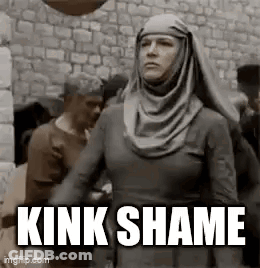 Woman In Hijab Standing In Front Of Stone Wall Saying Kink Shame GIF