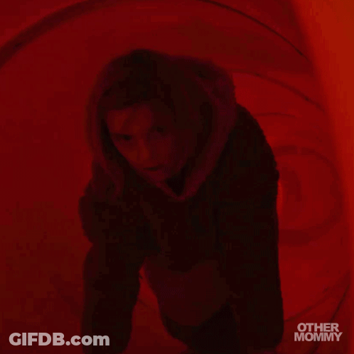 Woman In Hooded Jacket In Red Room With Other Mommy GIF