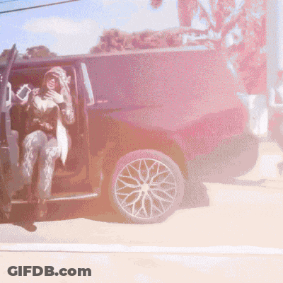 Woman In Hooded Jacket Sitting In Black SUV GIF