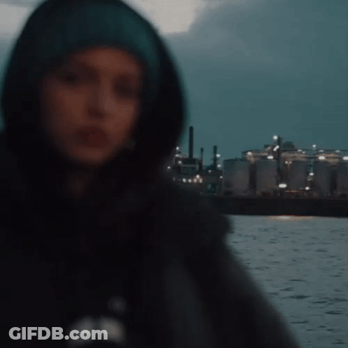 Woman In Hooded Jacket Standing Before Water GIF