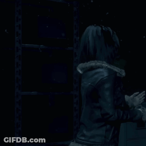 Woman In Hooded Jacket Standing In Dark GIF