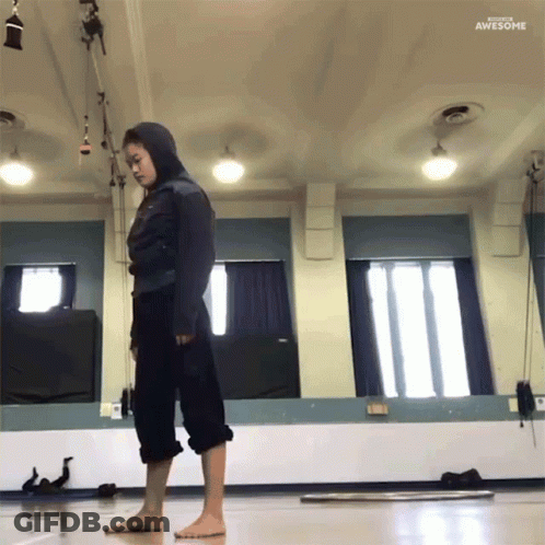 Woman In Hooded Jacket Standing In Front Of Mirror Saying Awesome GIF