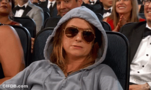 Woman In Hoodie And Sunglasses In Theater GIF