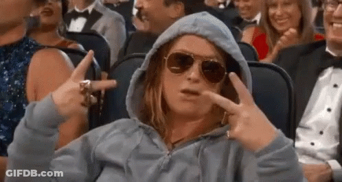 Woman In Hoodie And Sunglasses Making Peace Sign In Crowd GIF