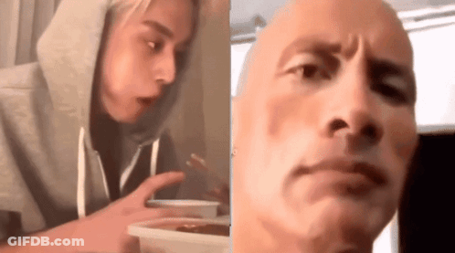 Woman In Hoodie Eating Food Next To Bald Man GIF