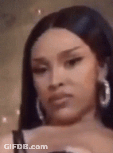 Woman In Hoop Earrings And Black Top GIF