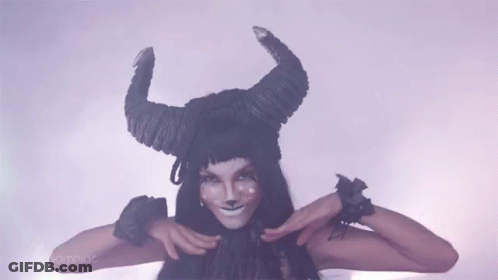 Woman In Horned Hat Making Funny Face GIF