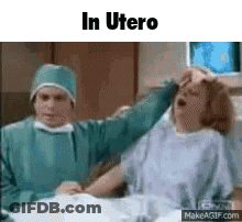 Woman In Hospital Bed With Doctor Holding Her Head GIF