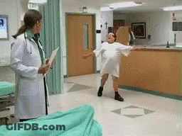 Woman In Hospital Gown Dancing Before Doctor Holding Clipboard GIF