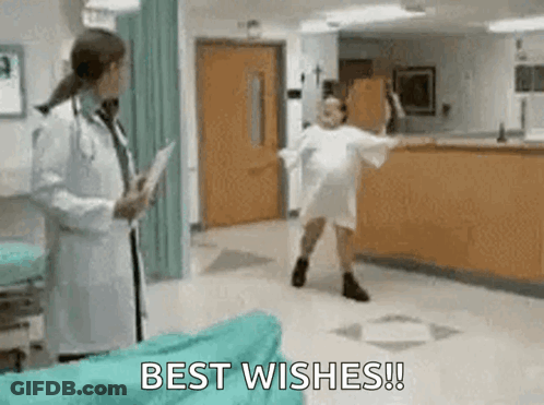Woman In Hospital Gown Dancing In Front Of Doctor GIF