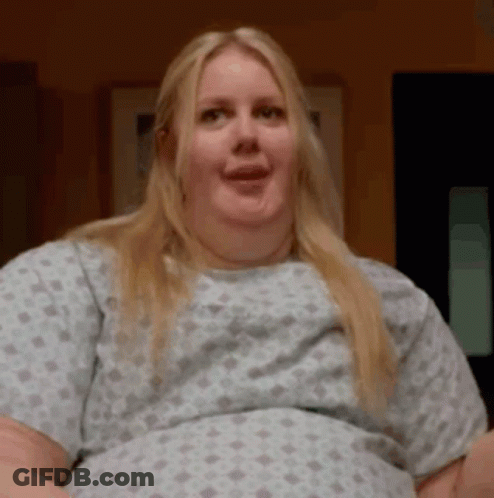 Woman In Hospital Gown Making Funny Face And Smiling GIF