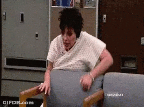 Woman In Hospital Gown Sitting GIF