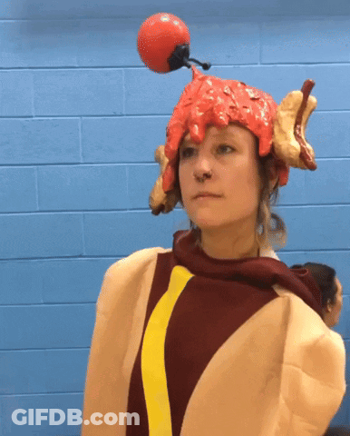 Woman In Hot Dog Costume With Red Ball On Head GIF