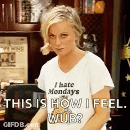 Woman In I Hate Mondays Shirt Standing At Desk GIF