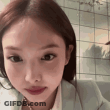 Woman In Jacket And Pearl Necklace GIF