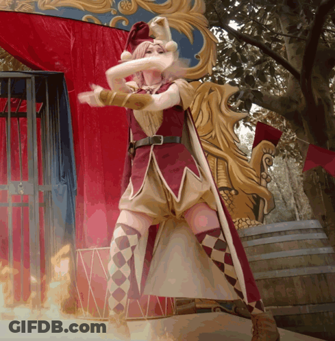 Woman In Jester Costume In Front Of Fire Barrel GIF
