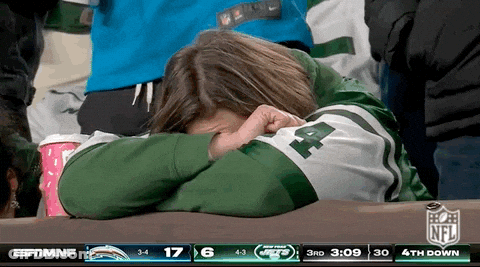Woman In Jets Jersey Covering Face While Watching Game GIF