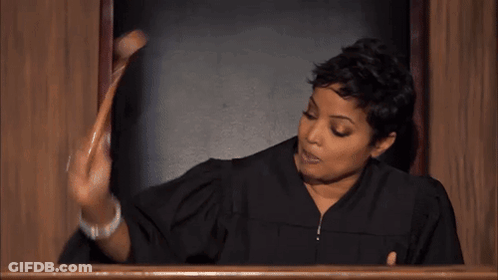 Woman In Judge Robe Holding Wooden Stick GIF