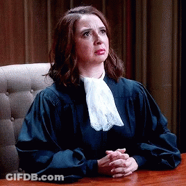 Woman In Judge Robe Sitting At Table GIF