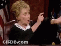 Woman In Judge's Chair Pointing GIF