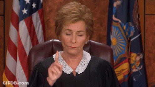 Woman In Judge's Chair With Flag GIF