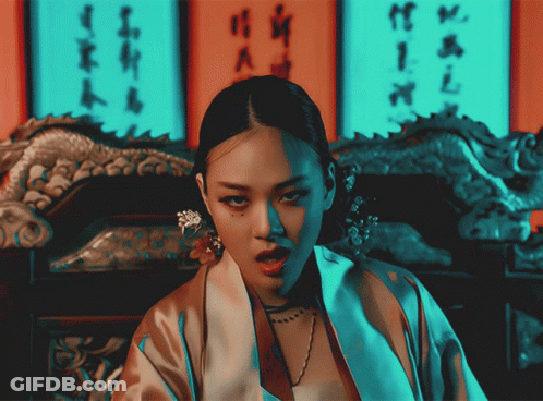 Woman In Kimono In Front Of Wall With Chinese Writing GIF