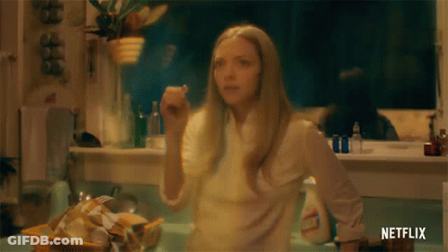 Woman In Kitchen With Netflix Logo GIF