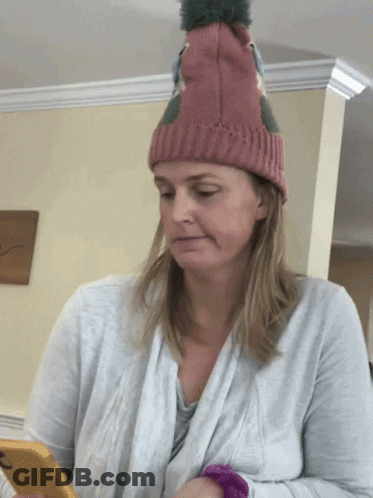 Woman In Knitted Hat Looking At Phone GIF
