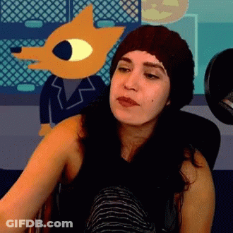 Woman In Knitted Hat Sitting In Front Of Cartoon Character GIF
