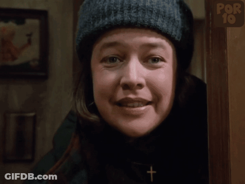 Woman In Knitted Hat Smiling In Front Of Por 10 Sign GIF