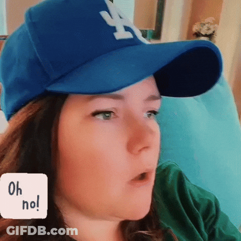Woman In LA Dodgers Hat On Couch GIF