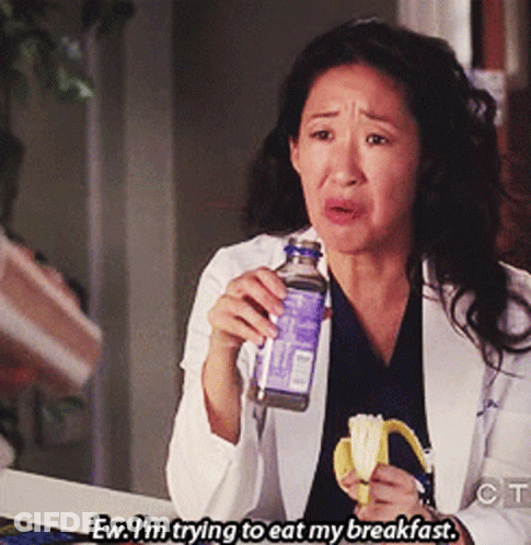 Woman In Lab Coat Eating Banana And Drinking Water GIF