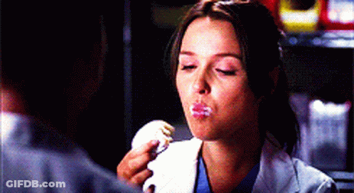 Woman In Lab Coat Eating Cake GIF