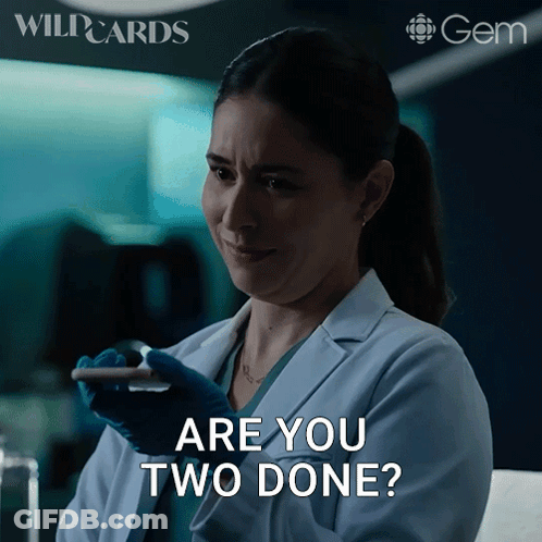 Woman In Lab Coat Holding Cell Phone Asking Are You Two Done GIF