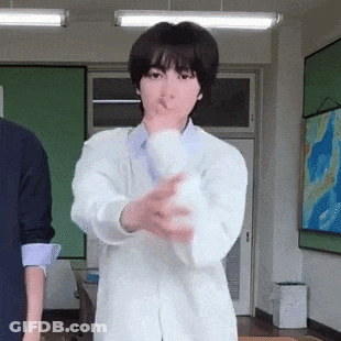 Woman In Lab Coat Holding White Object GIF