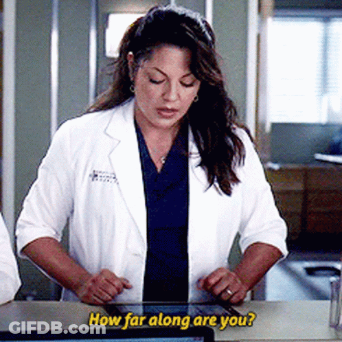 Woman In Lab Coat Looking At Tablet Saying How Far Along Are You GIF