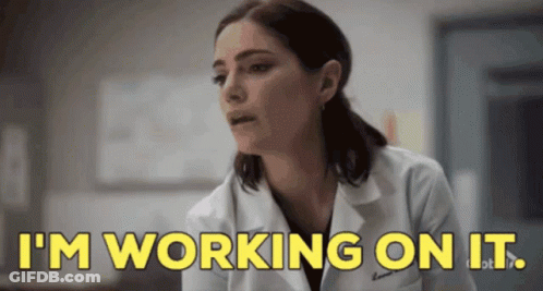 Woman In Lab Coat Saying I'm Working On It GIF