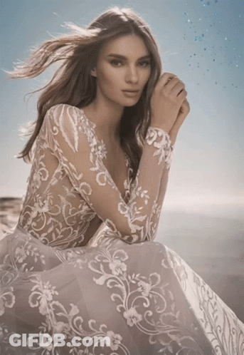 Woman In Lace Dress Looking At Camera GIF