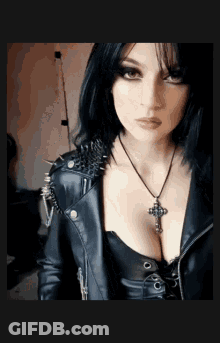 Woman In Leather Jacket And Cross Necklace GIF