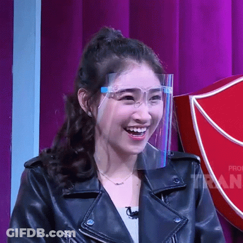 Woman In Leather Jacket And Face Shield Smiles GIF