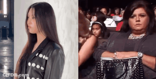 Woman In Leather Jacket Beside Woman With Purse GIF