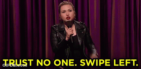 Woman In Leather Jacket Holding Microphone Saying Trust No One Swipe Left GIF