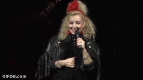 Woman In Leather Jacket Holding Microphone GIF