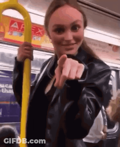 Woman In Leather Jacket Holding Yellow Railing On Bus GIF