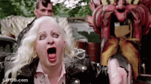 Woman In Leather Jacket Screaming At Mustache Statue GIF