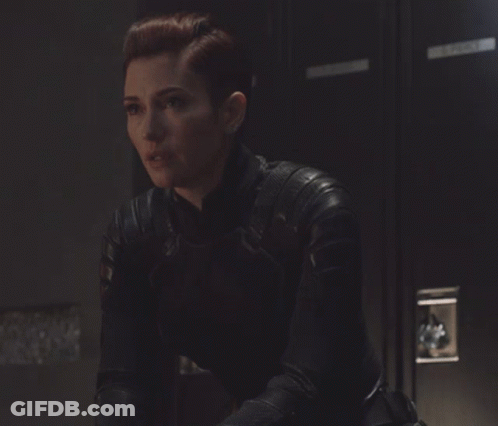Woman In Leather Jacket Sitting By Locker GIF