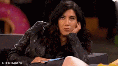 Woman In Leather Jacket Sitting With Hand On Face GIF