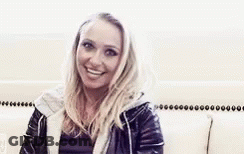 Woman In Leather Jacket Smiling At Camera GIF