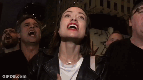 Woman In Leather Jacket Smiling Looking Up GIF