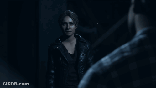 Woman In Leather Jacket Standing In Dark GIF